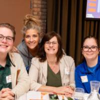 four people at luncheon table photo 2
